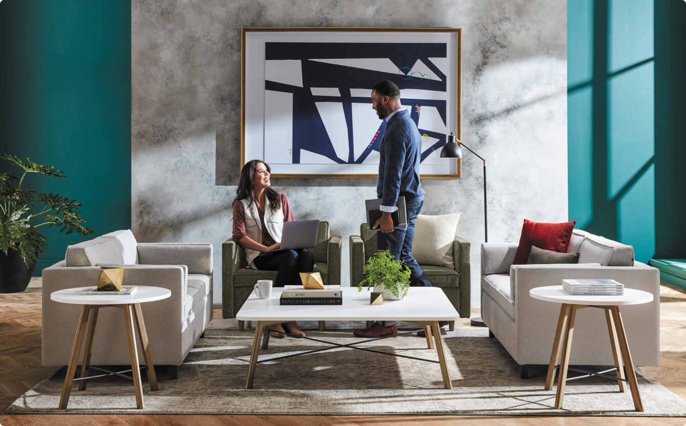 Stylish office lounge with modern armchairs, white coffee tables, and artwork